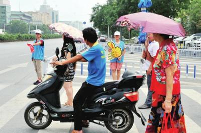 　　青山绿水青年志愿者服务队的志愿者在炎热的酷暑下坚持开展《公益街-做文明有礼北京人》活动